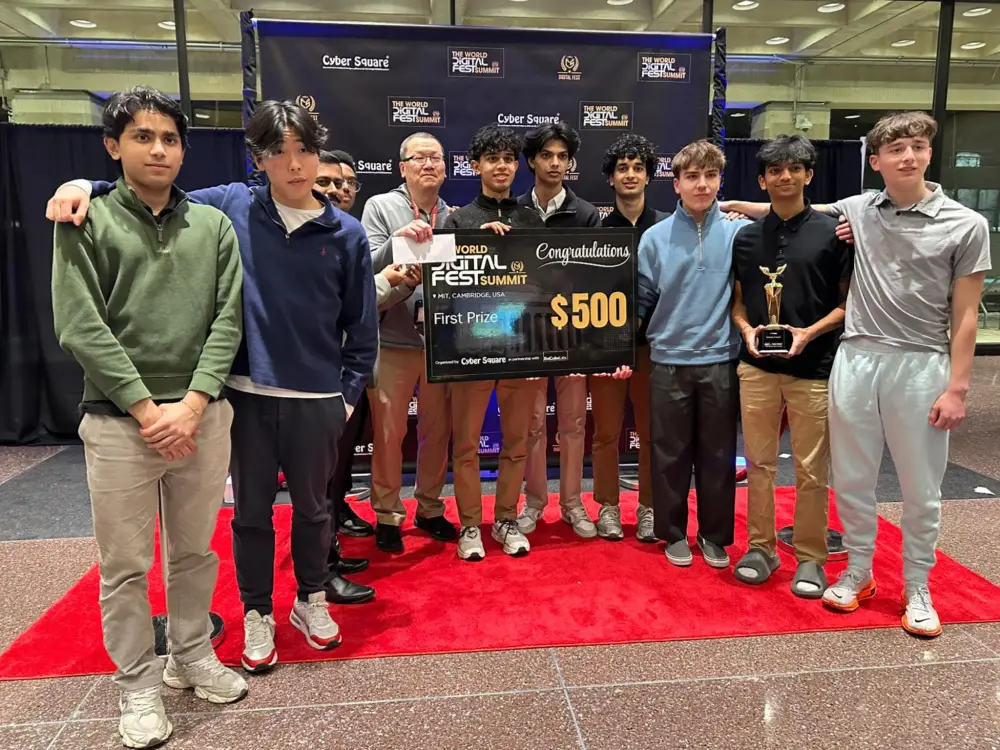 A winning student team holding a first-prize cheque and trophy at the World Digital Fest Summit